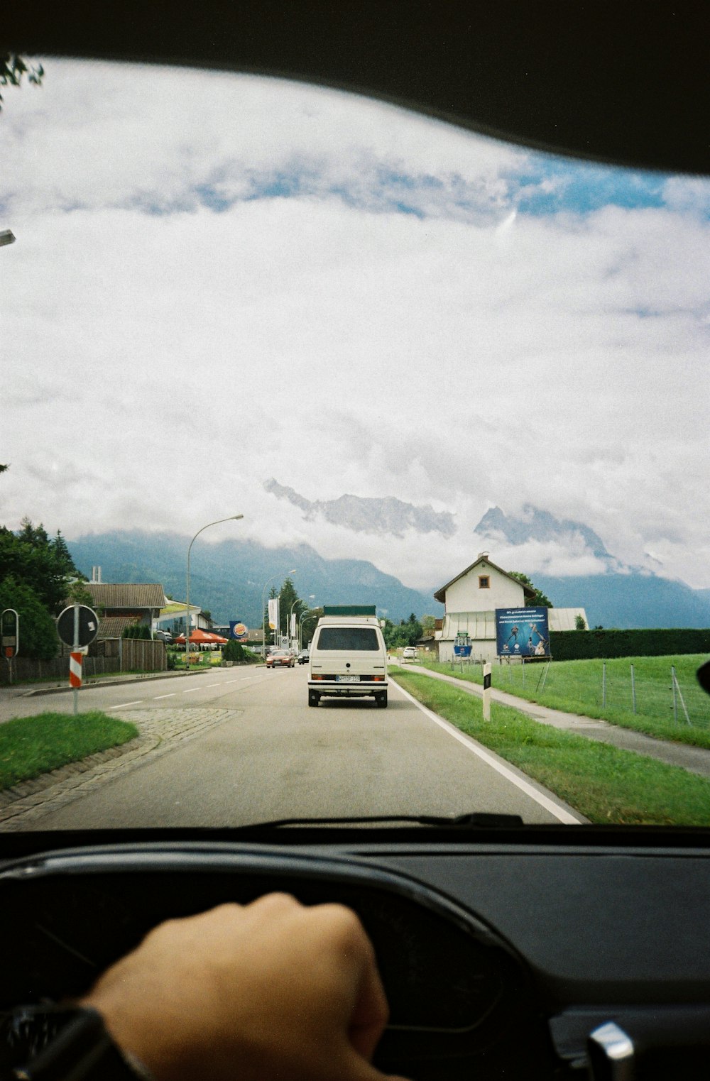 a person driving a car down a street