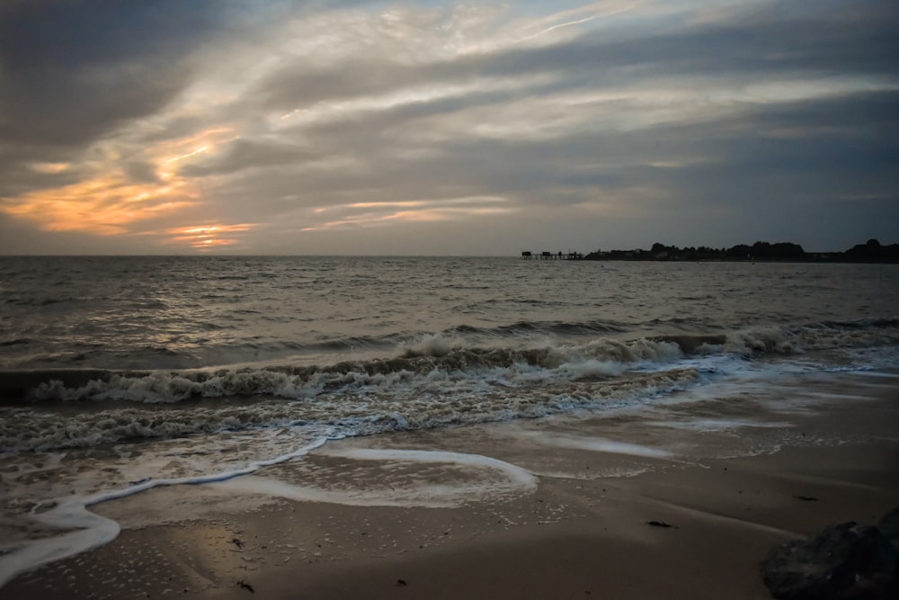 a beach with waves coming in to shore