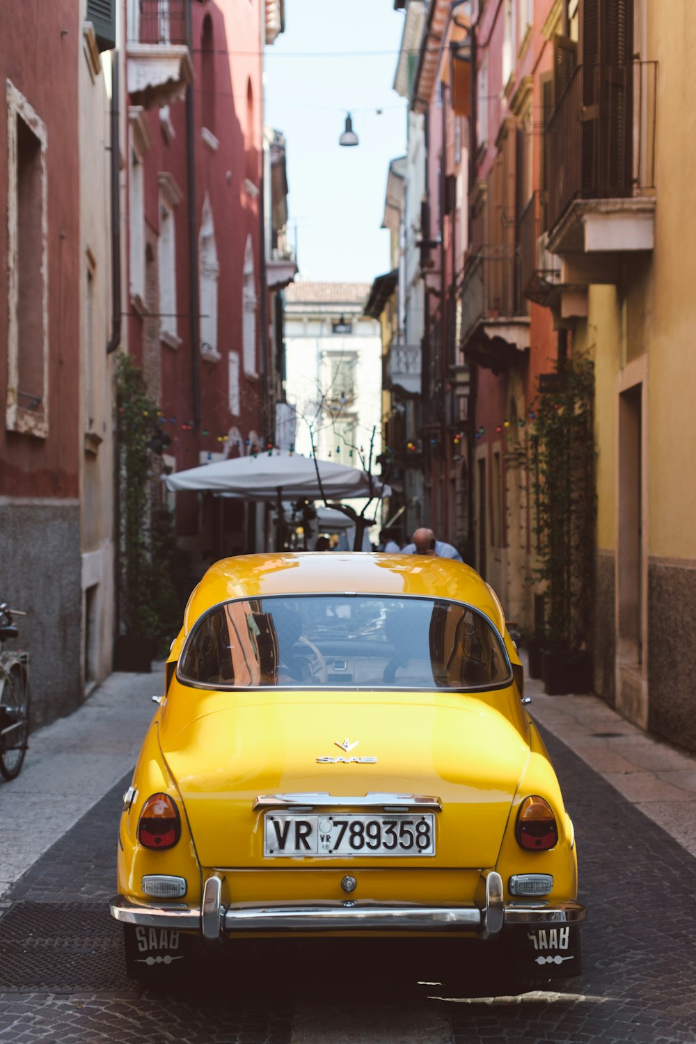 a yellow car parked on the side of a street