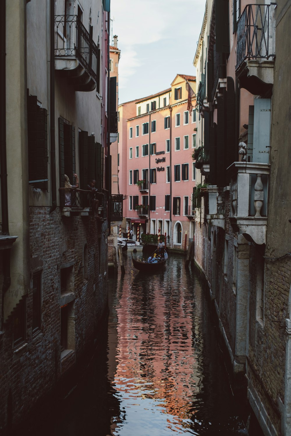 a narrow canal in a city with buildings on either side