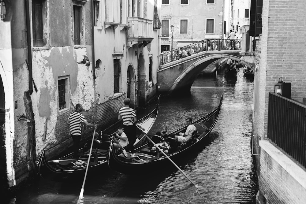 a couple of people riding on top of a boat down a river