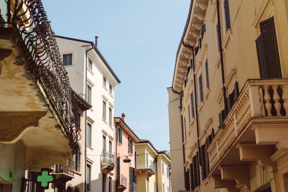 a narrow street lined with tall buildings and balconies