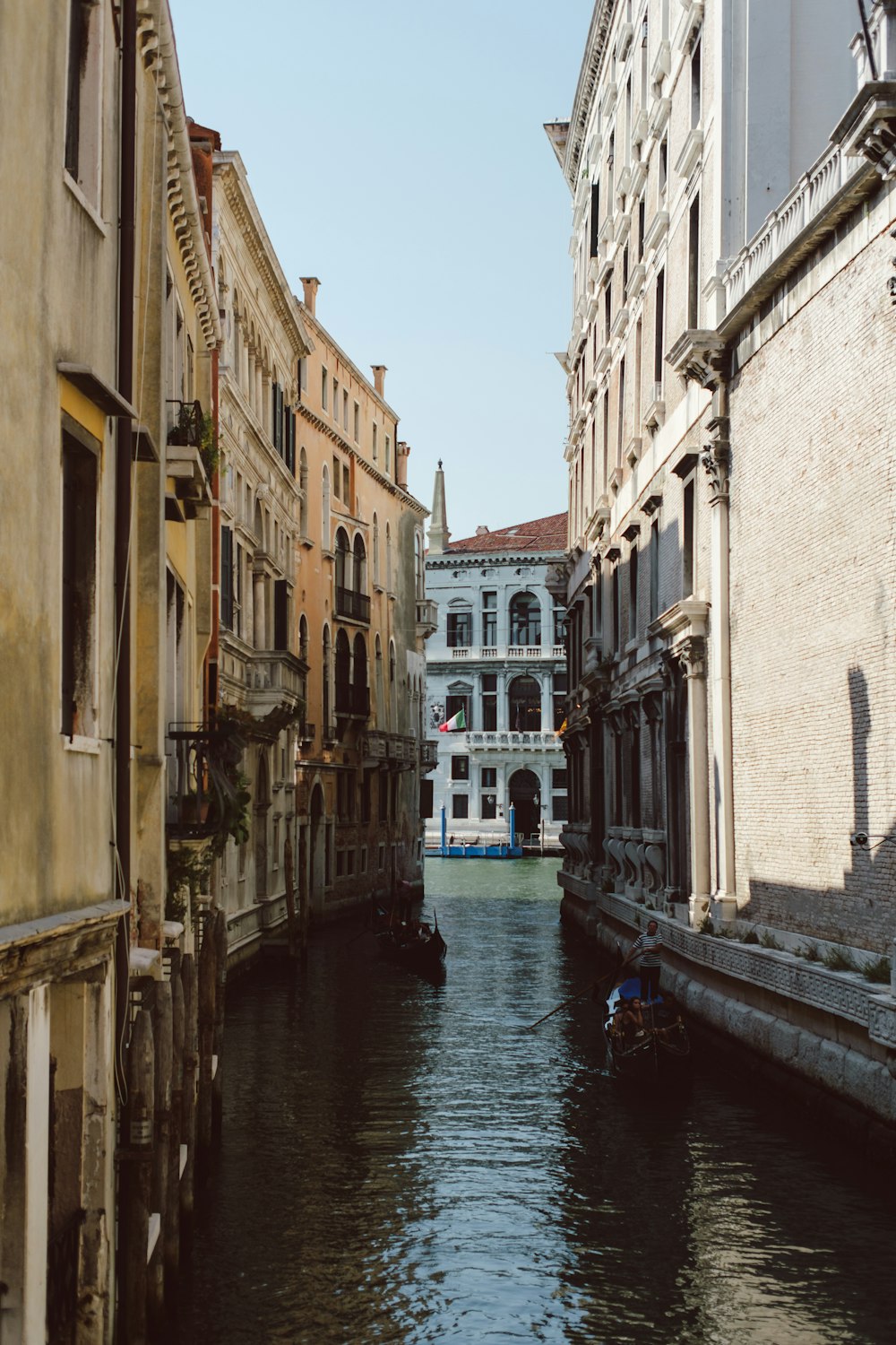 a narrow canal with buildings on both sides