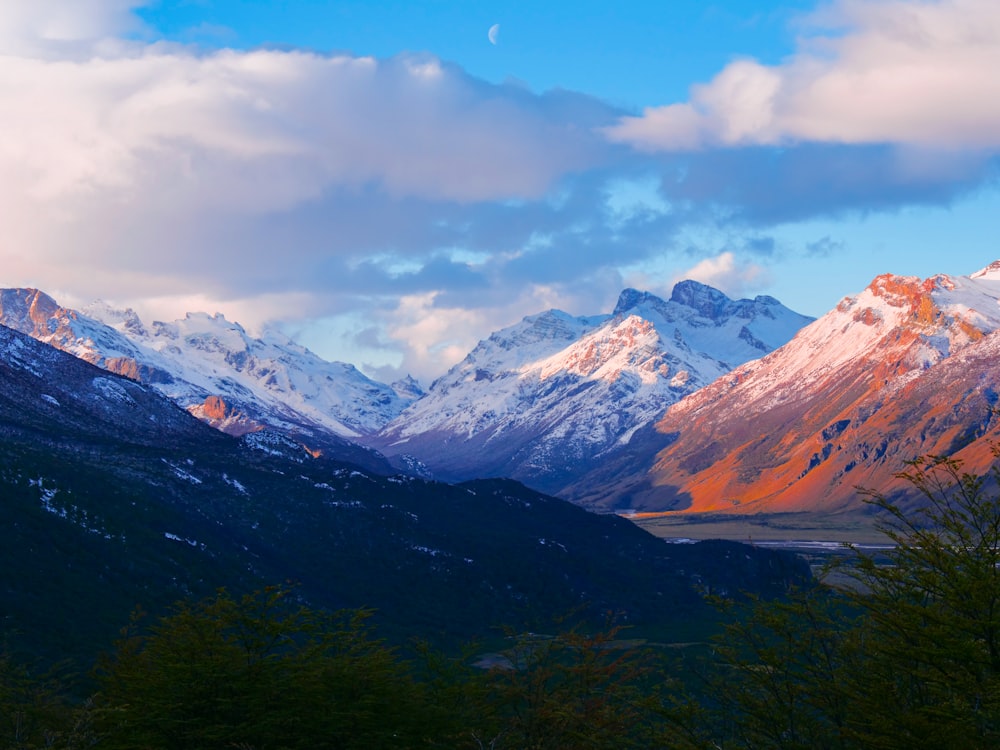 a view of a mountain range with snow on it