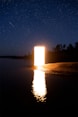 a large open door sitting in the middle of a lake