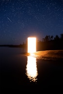 a large open door sitting in the middle of a lake