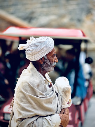 A man with a white turban holding a baby