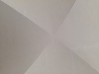 An abstract composition of geometric shapes in warm slate and pearl white, evoking intentional design.