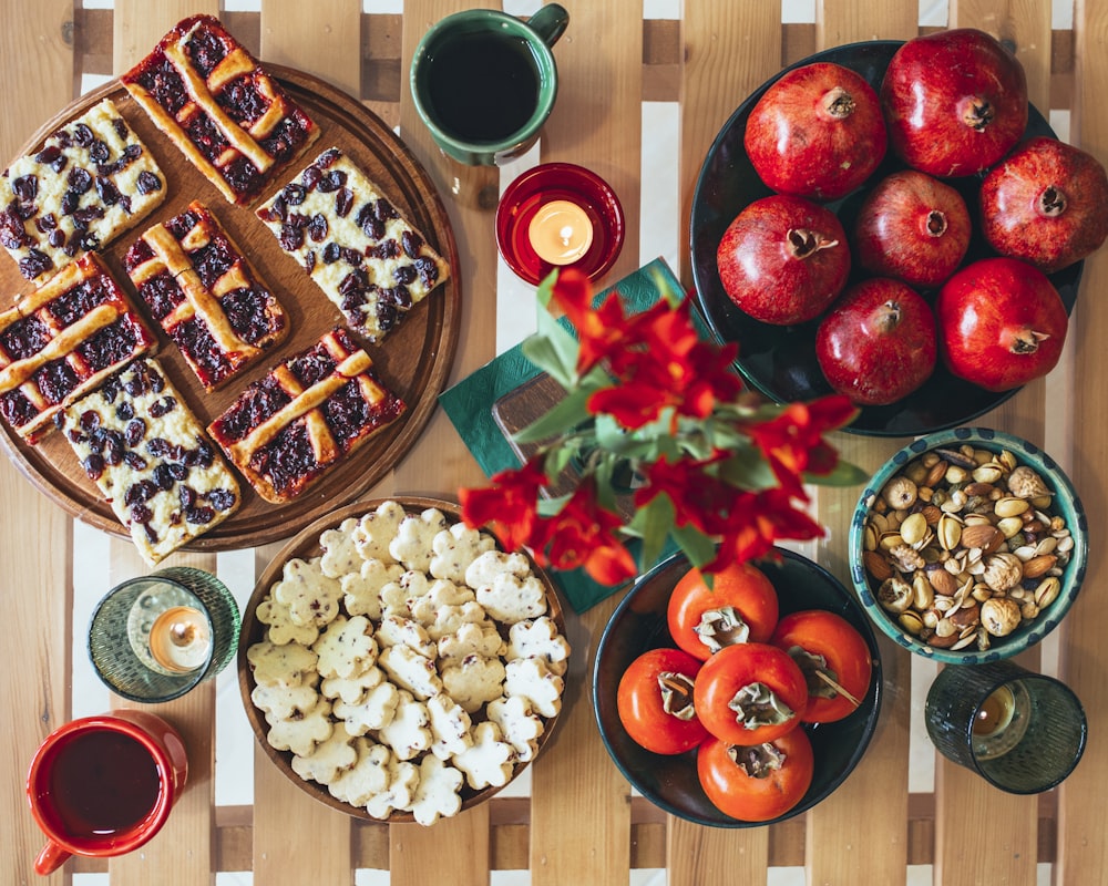 a wooden table topped with plates of food