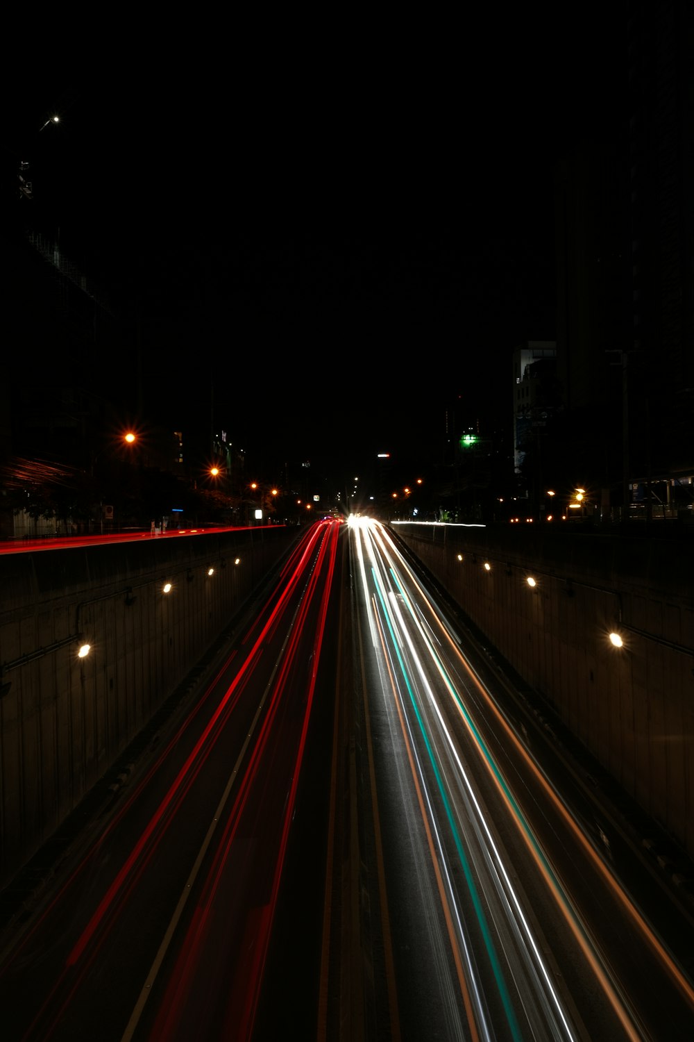 a long exposure photo of a highway at night