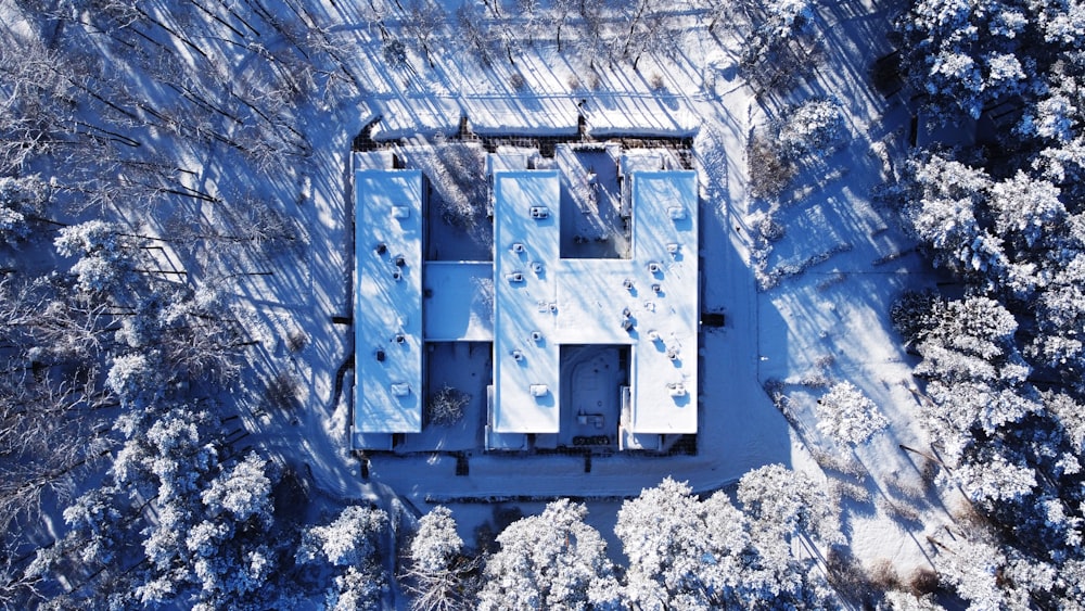 an aerial view of a house in the woods