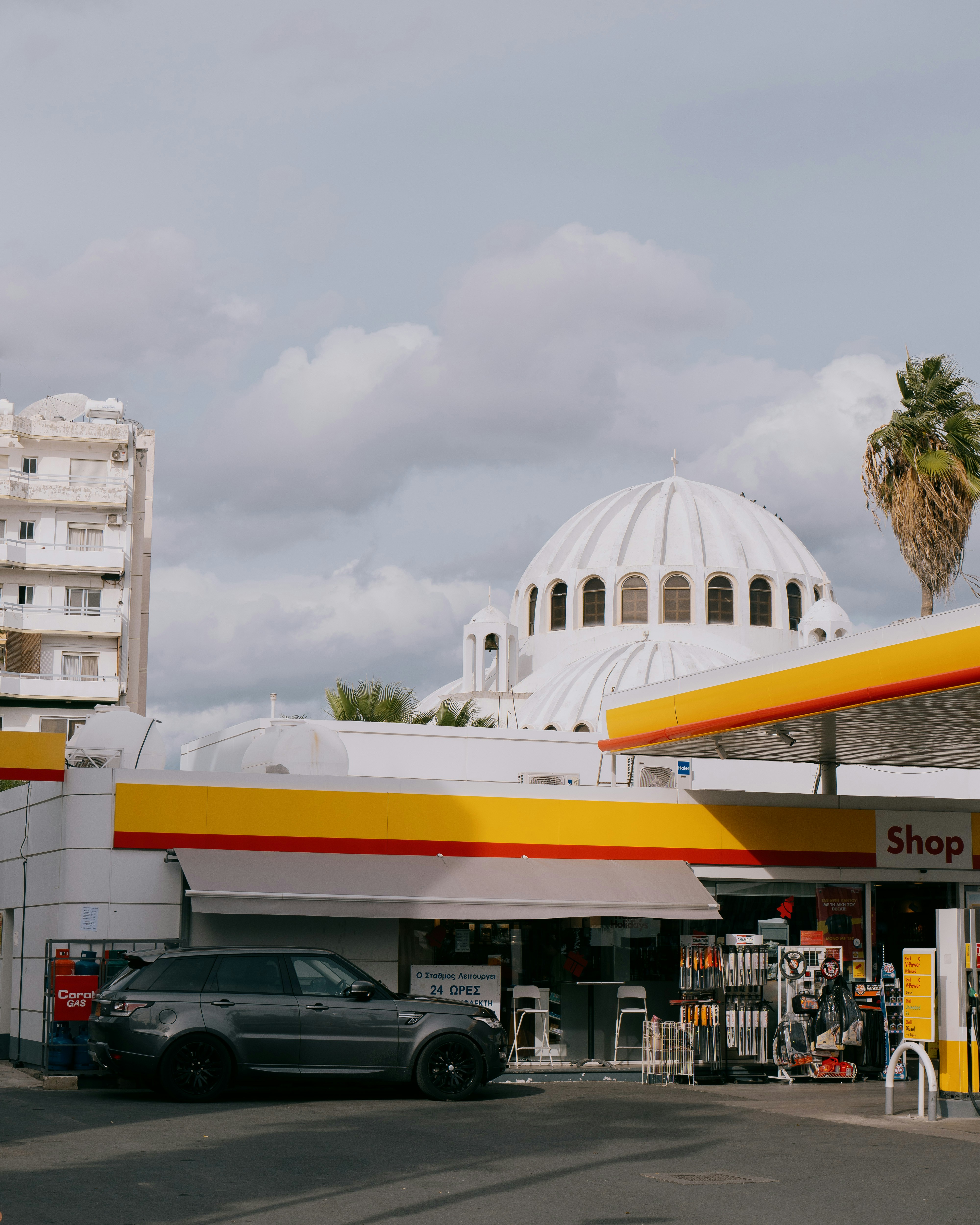 a car parked in front of a gas station
