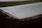 An old, thick stack of handwritten documents with visible texture and slight yellowing of the pages. The focus is on the edges, highlighting the layered, slightly curled paper.