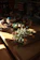 Close-up of handmade mixed media crafts displayed on a wooden table with soft natural light.