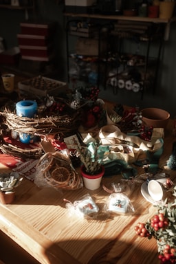 Cozy Christmas decorations with warm lights and festive ornaments on a rustic wooden table.