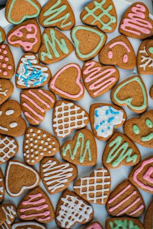 Artfully arranged baby shower cookies featuring soft ivory and blush hues with delicate icing details.