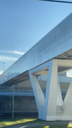 Completed urban bridge with clean lines and modern design against a clear sky.