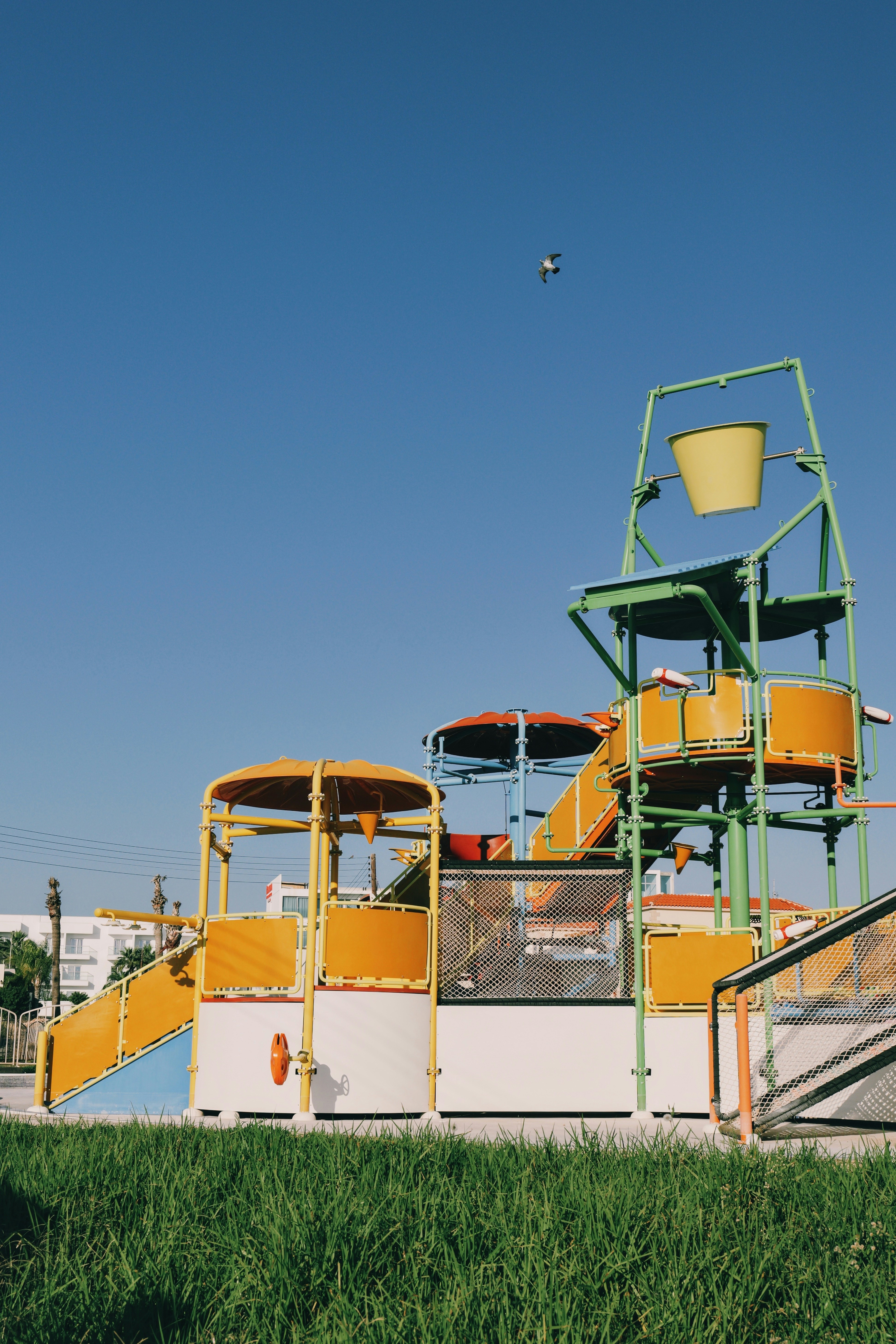 a yellow and white roller coaster in the grass