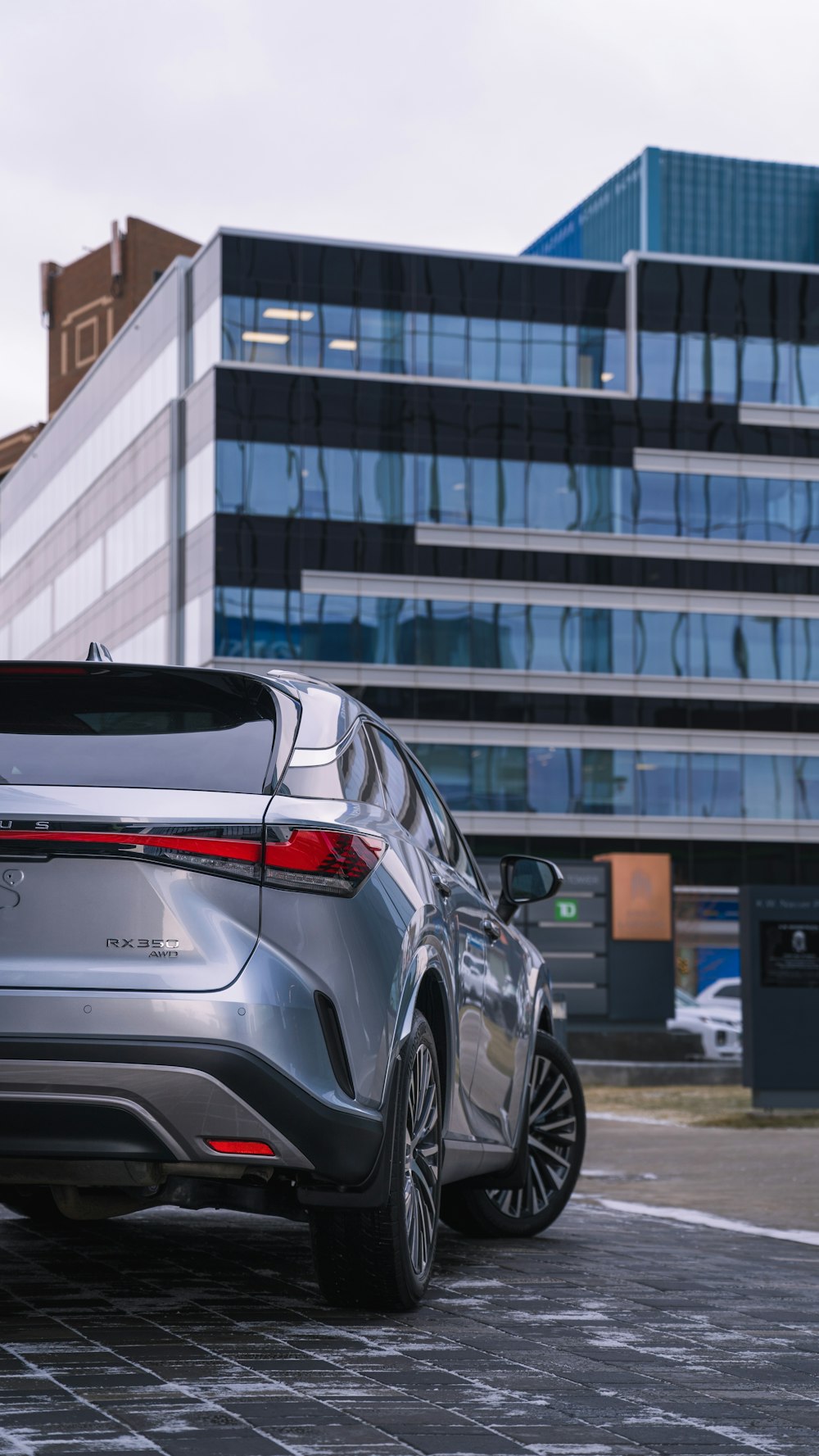 a silver car parked in front of a building