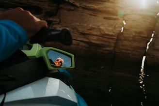 Close-up of a jet ski’s handle and dashboard glistening with sea spray.