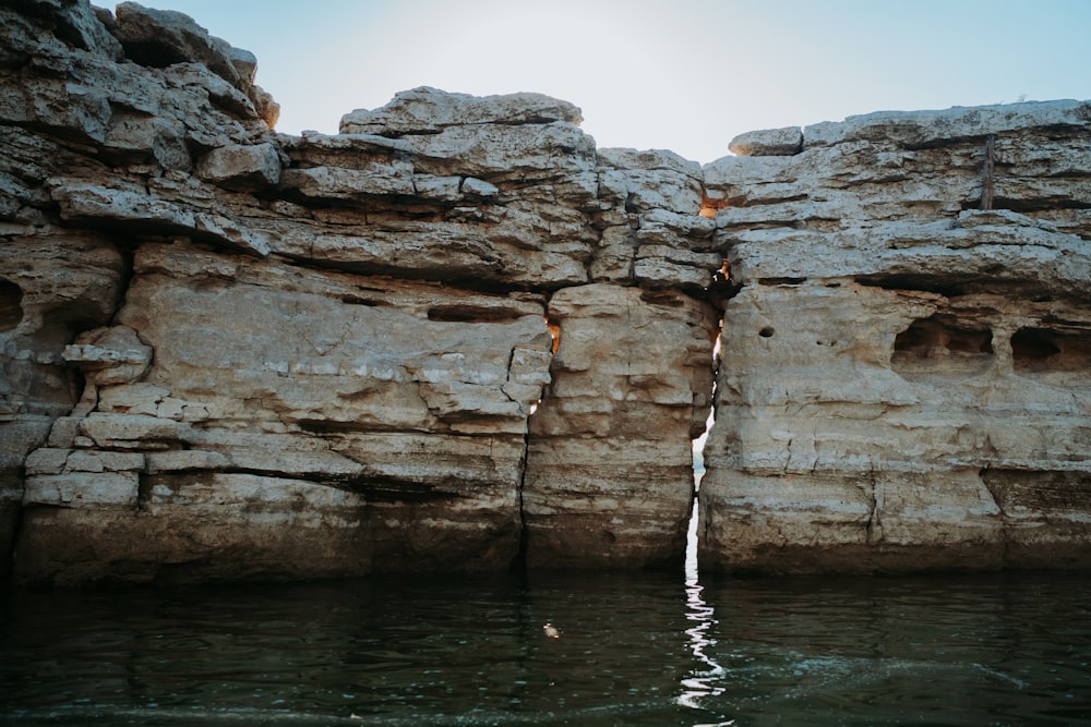 a rock formation in the middle of a body of water