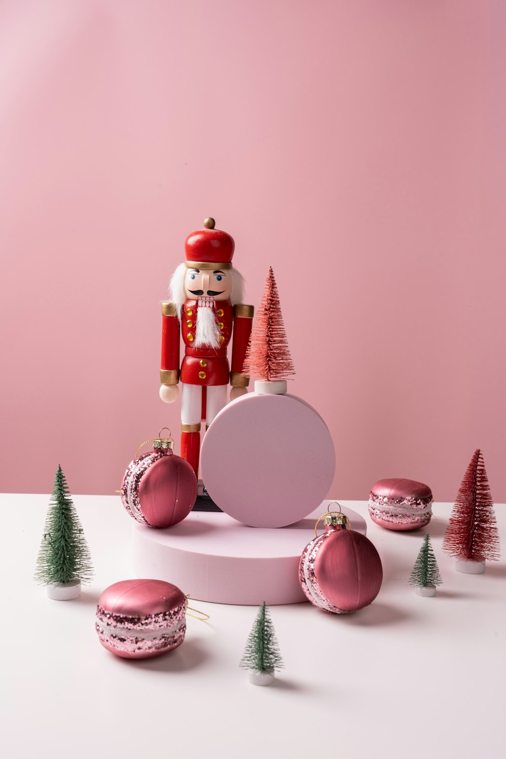 a nutcracker is standing on a table surrounded by christmas decorations