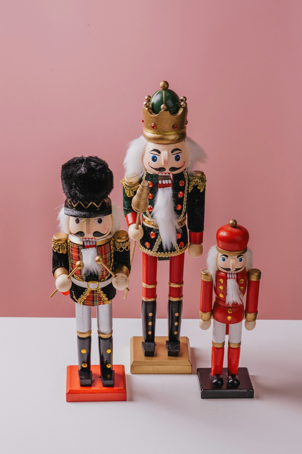 three wooden nutcrackers are standing next to each other
