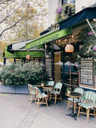 Cozy café terrace with colorful awnings providing shade to customers.