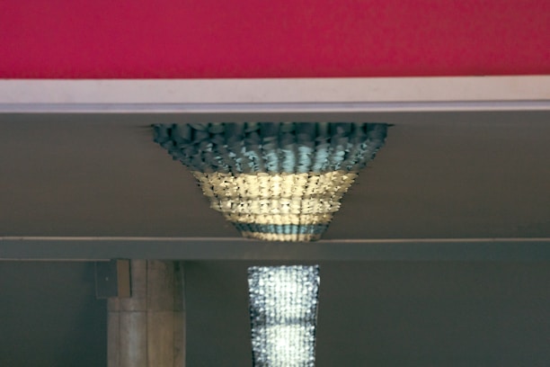 Close-up of matte metallic accents on a sleek, custom-designed interior fixture reflecting subtle light.