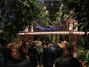 Engineers examining a scale model of a suspension bridge in a bright office.