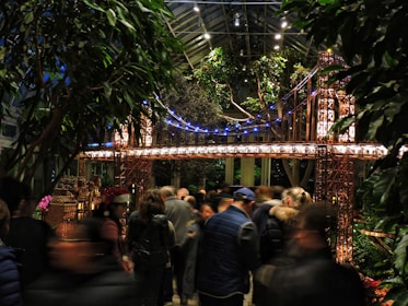 Engineers examining a scale model of a suspension bridge in a bright office.