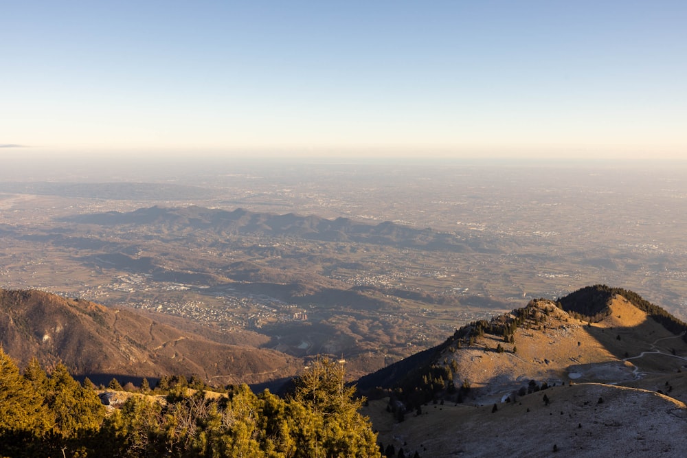 a view of a valley and mountains from the top of a mountain