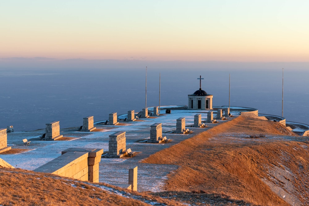 a church on top of a hill with snow on the ground