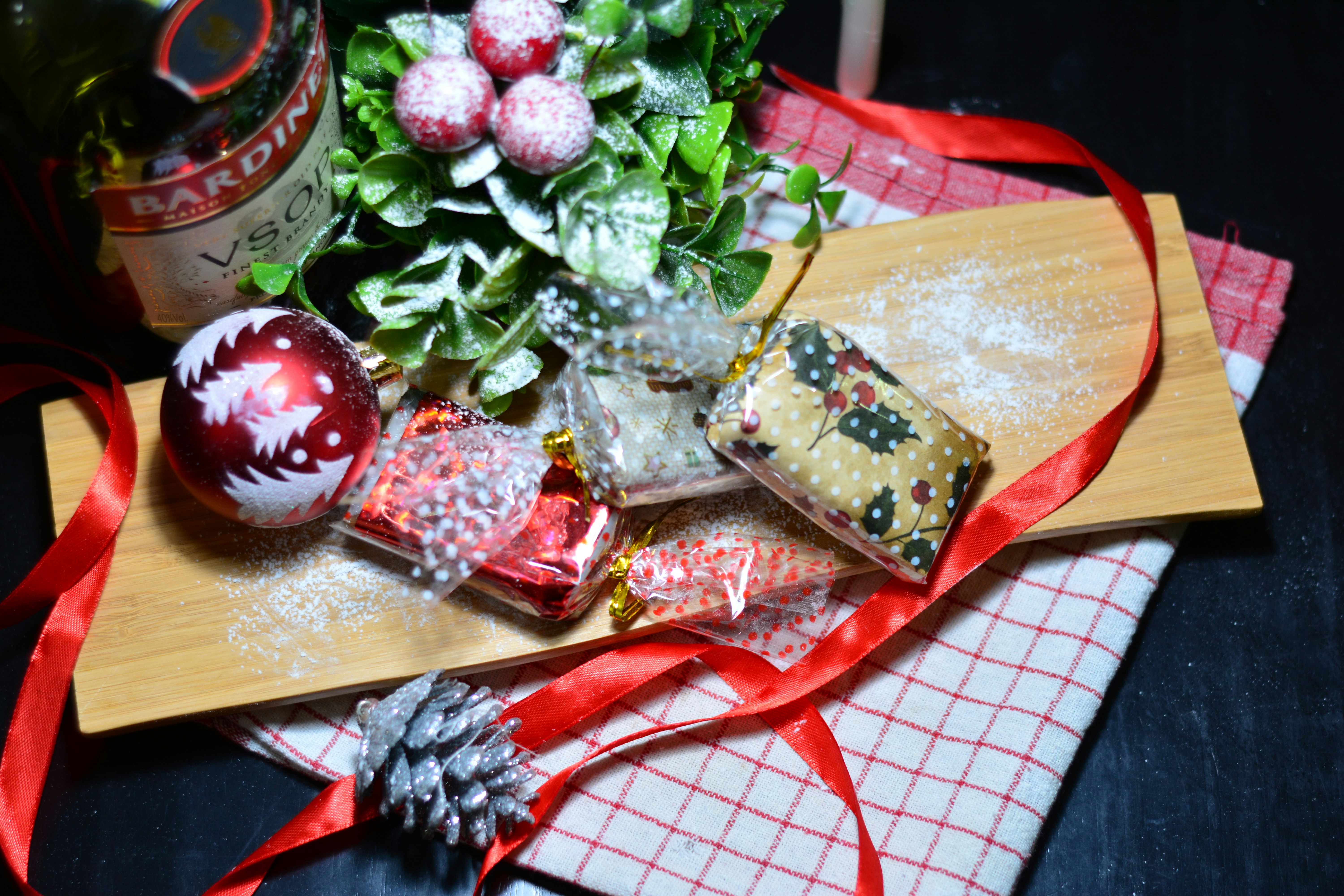 a table topped with a wooden cutting board covered in candy