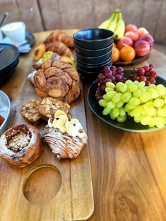 An assortment of pastries on a wooden serving board.
