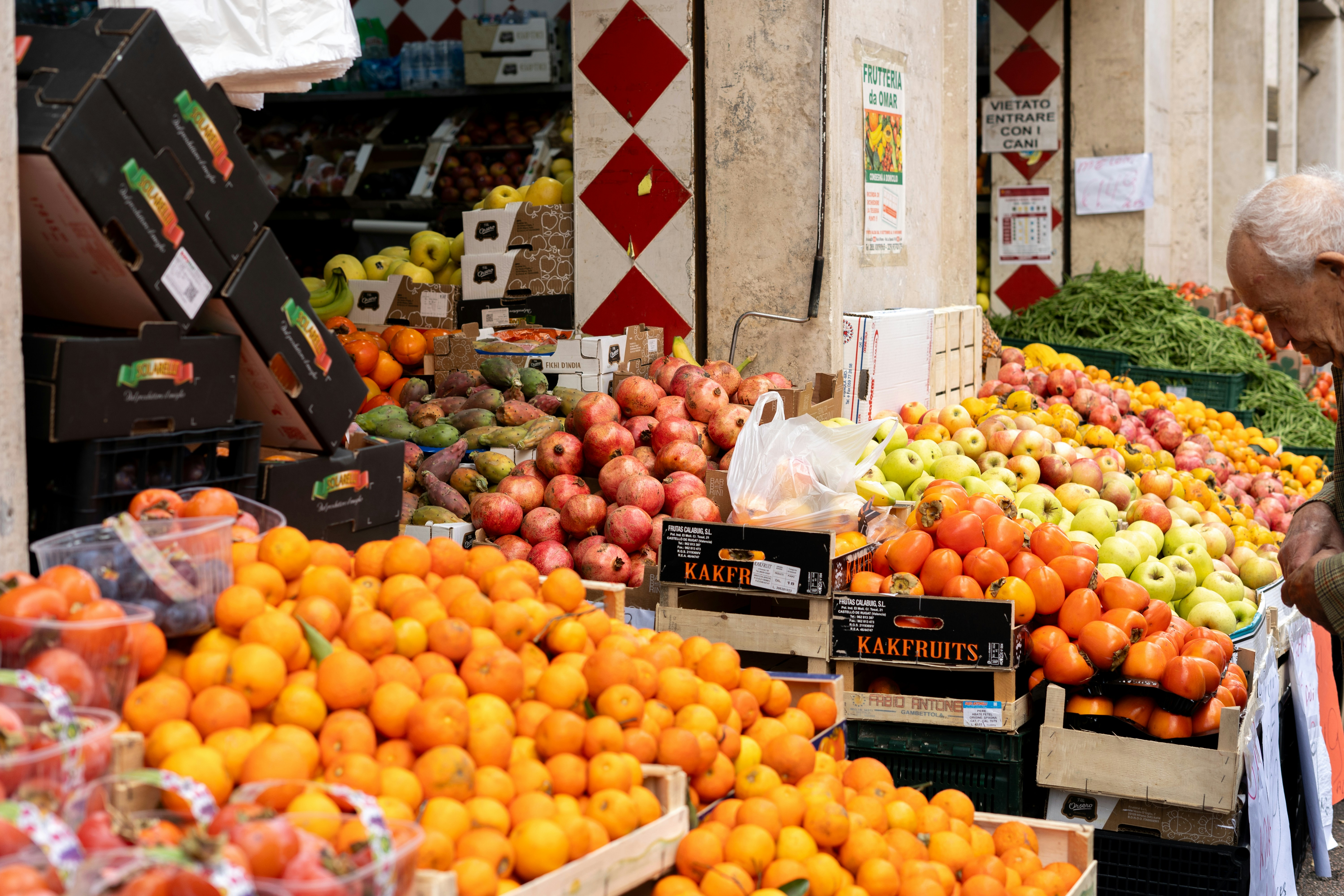 a man is looking at a fruit stand