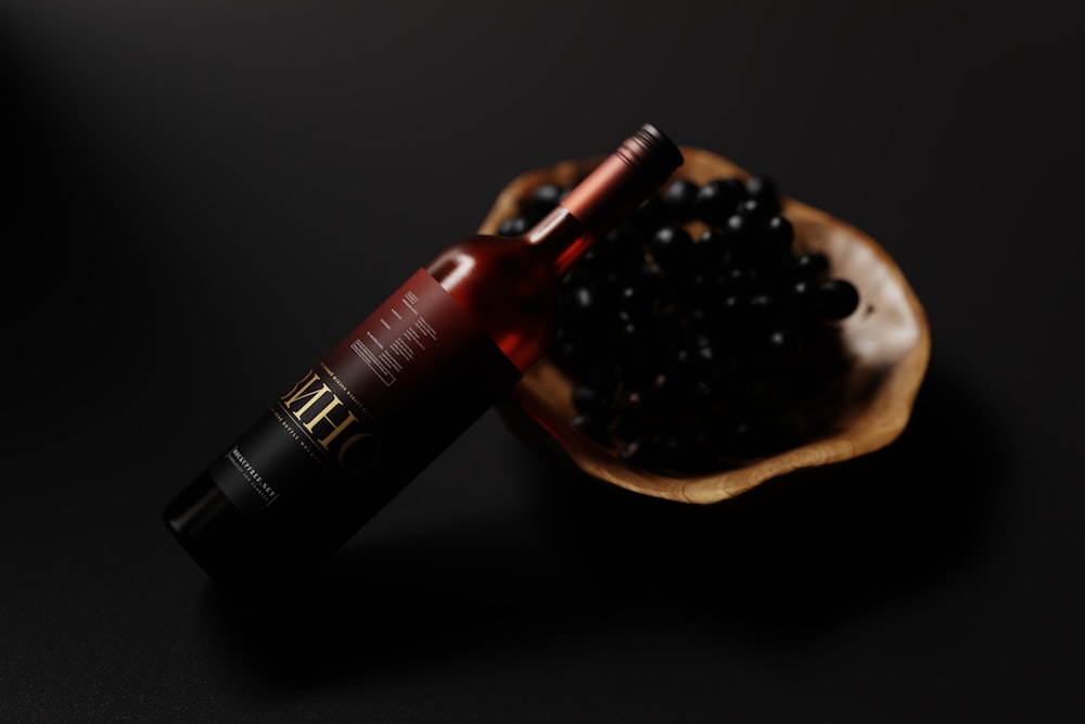 a bottle of wine sitting on top of a wooden spoon