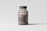 A transparent brown plastic pill bottle with a dark cap is placed against a light gray background. The label on the bottle reads 'mocp' and includes additional text and a website link at the bottom. The bottle's contents appear to be small brown pills.