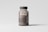 A transparent brown plastic pill bottle with a dark cap is placed against a light gray background. The label on the bottle reads 'mocp' and includes additional text and a website link at the bottom. The bottle's contents appear to be small brown pills.