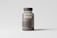 A transparent brown plastic pill bottle with a dark cap is placed against a light gray background. The label on the bottle reads 'mocp' and includes additional text and a website link at the bottom. The bottle's contents appear to be small brown pills.
