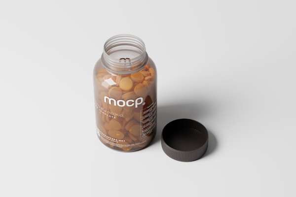 A transparent plastic bottle filled with round, orange tablets, accompanied by a detached black cap. The label reads 'mocp' and includes additional text in a smaller font. The bottle is placed on a light gray surface.