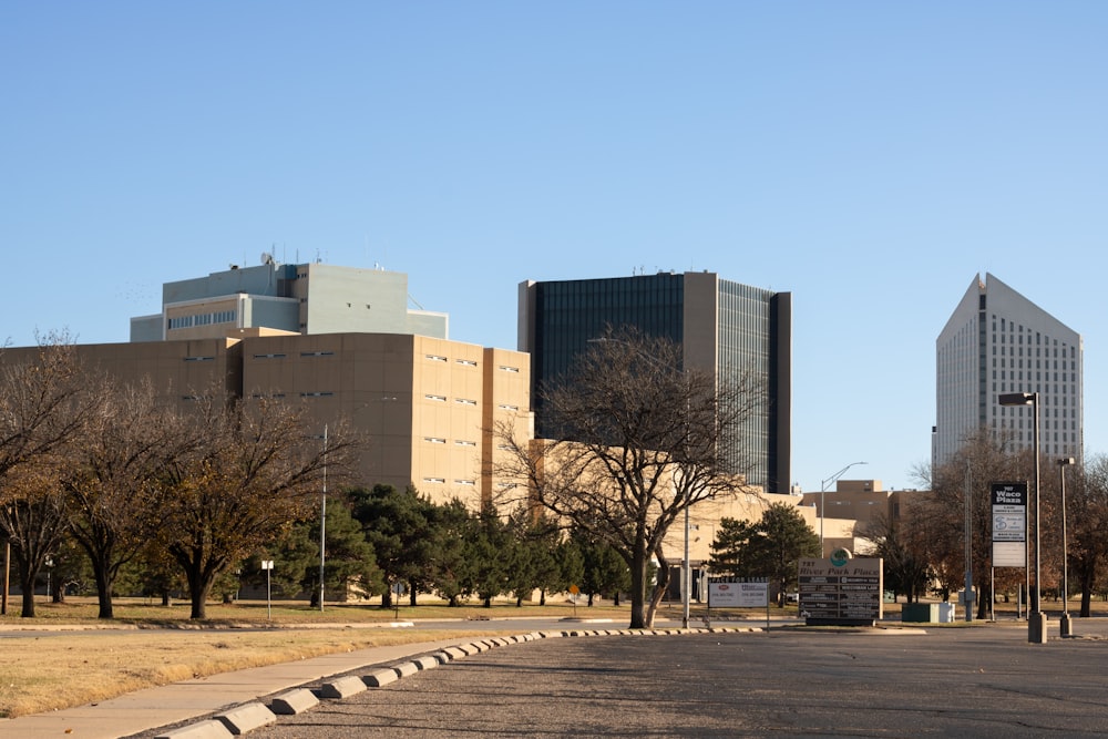 a city street with tall buildings in the background