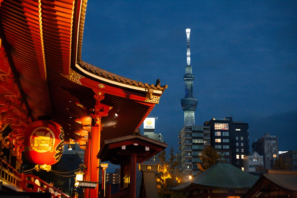 a view of a city at night with a tall building in the background