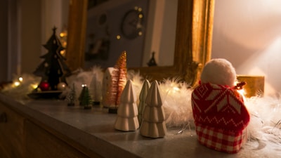 A cozy Christmas corner showcasing nativity sets, stockings, and LED acrylic writing boards.