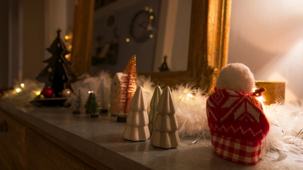 Cozy Christmas-themed clothing displayed on a festive background with twinkling lights.