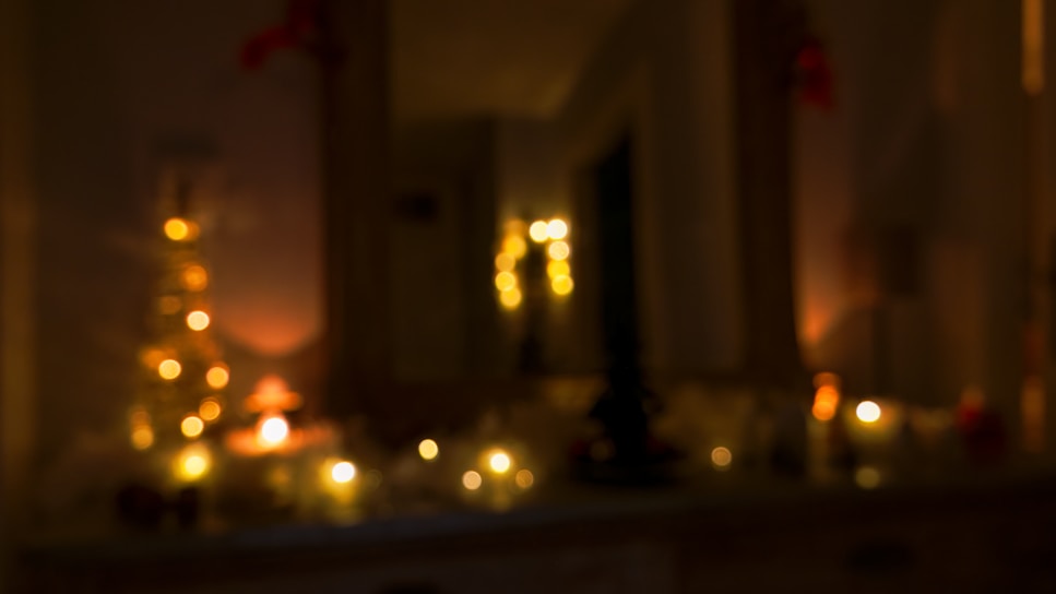 A softly blurred background photo of a cozy newsroom with warm lighting and scattered papers.