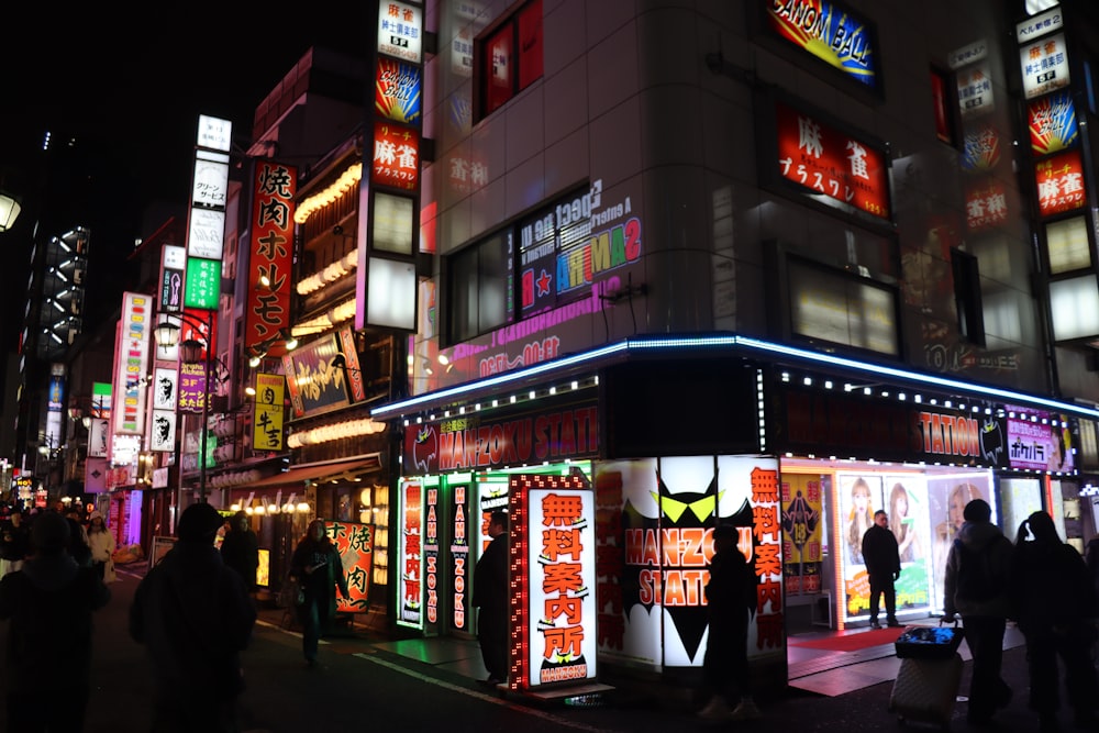 a busy city street at night with neon lights