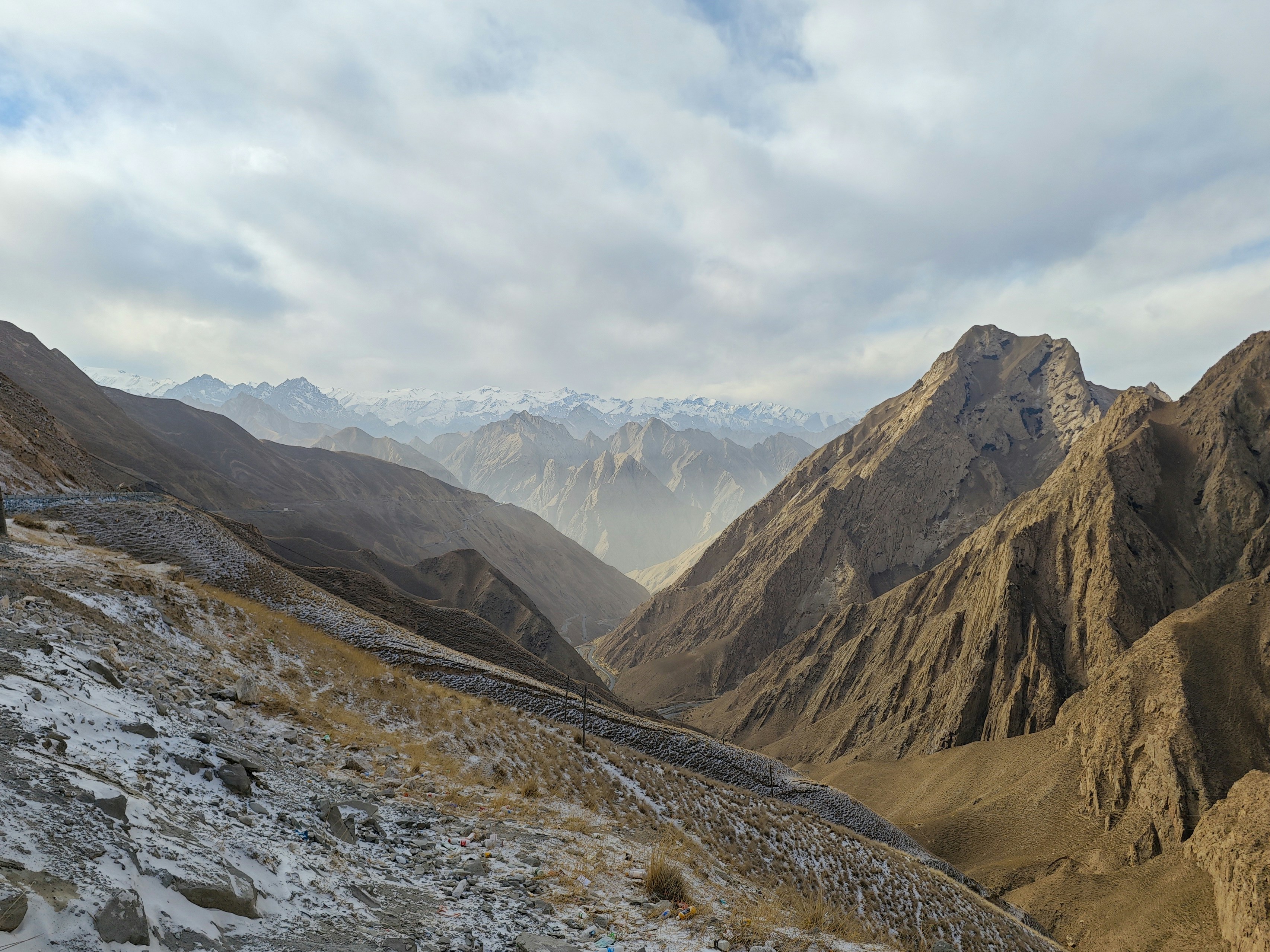 a view of a mountain range with snow on the ground