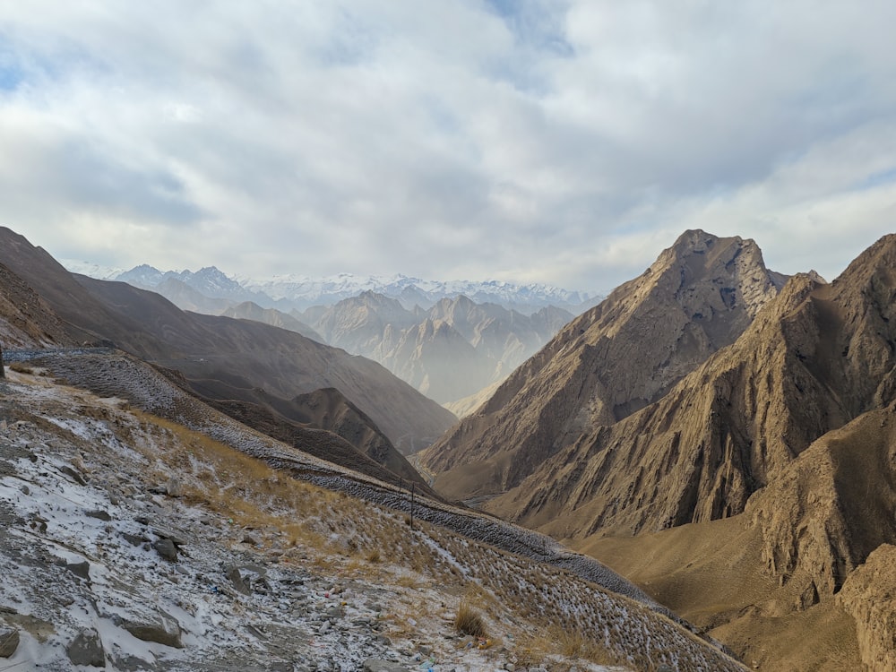 a view of a mountain range with snow on the ground