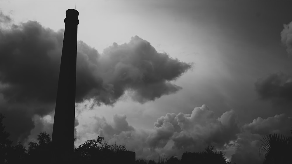 a black and white photo of a smoke stack